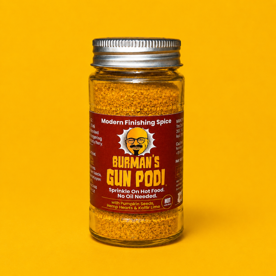 Jar of Burman's Gun Podi spice on a yellow background